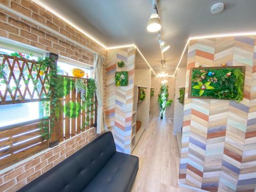 a room with a couch and a window at Hotel Jungle fun fun in Osaka