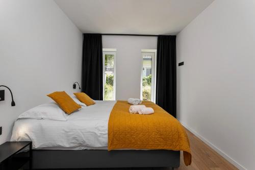 a bedroom with a bed with a pink towel on it at Luxe strandappartement met zonneterras & parking in Koksijde