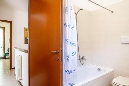 a bathroom with a shower and a tub and a toilet at Casa Luz in Giglio Porto