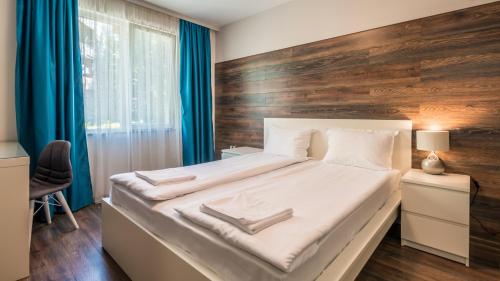 a bedroom with a large bed with a wooden headboard at The old Bakery Apartments in Plovdiv