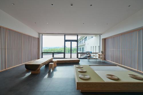 a large room with tables and a large window at くろしお想 in Shirahama