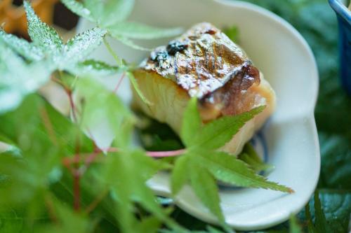 a white plate with a piece of food on it at くろしお想 in Shirahama