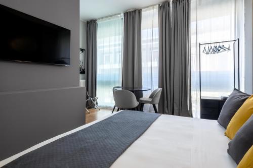 a bedroom with a bed with a television and a desk at SWEET LIFE 2 LUXURY and DESIGN APARTMENT in Bari