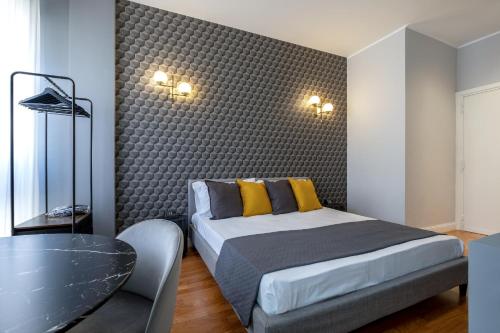 a bedroom with a king sized bed and a table at SWEET LIFE 2 LUXURY and DESIGN APARTMENT in Bari