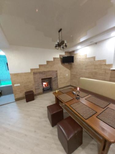 a living room with a table and a fireplace at дача in Odesa