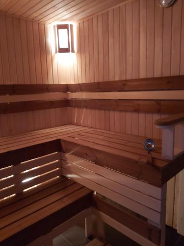 a small wooden sauna with a light in it at дача in Odesa