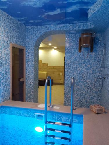 a bathroom with a swimming pool in a room at дача in Odesa