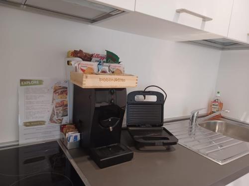 a kitchen counter with a coffee maker and a sink at Superior Beach Aparthotel in Lido di Jesolo