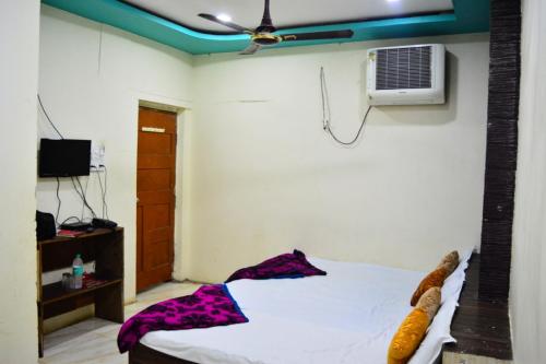 a bedroom with a bed and a air conditioner at Hotel Bholenath Palace - Infront of Mahakal Temple in Ujjain