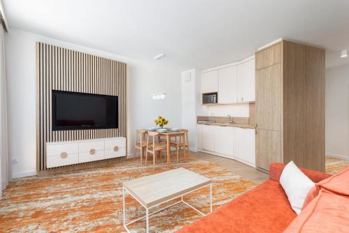 a living room with a couch and a table at Sun & Beach Apartments Bel Mare with Parking by Noclegi Renters in Międzyzdroje