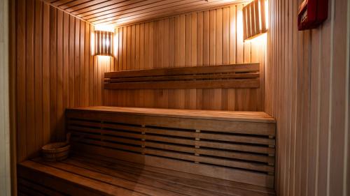 a sauna with wooden walls and wooden floors and lights at Gori Inn in Gori
