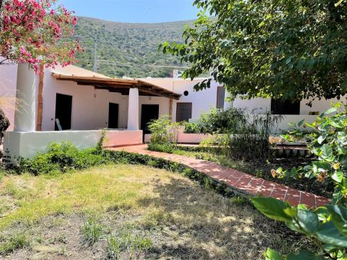 a house with a garden in front of it at Casa Bouganville in Pollara