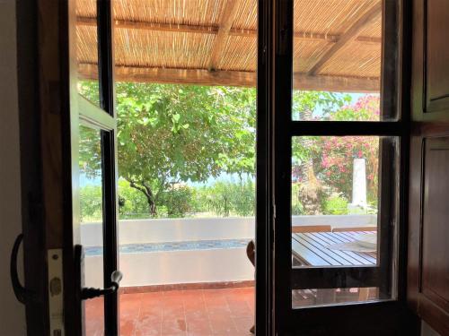an open door with a view of a garden outside at Casa Bouganville in Pollara