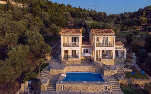 an aerial view of a house with a swimming pool at Sun And Stone in Athani