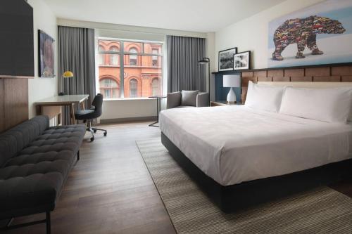 ポートランドにあるThe Bidwell Marriott Portlandのベッドとデスクが備わるホテルルームです。