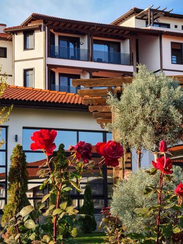 a building with red roses in front of it at Wine & Spa Complex Starosel in Starosel