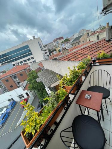 a balcony with chairs and plants on a building at Elegance Aparts Cihangir in Istanbul