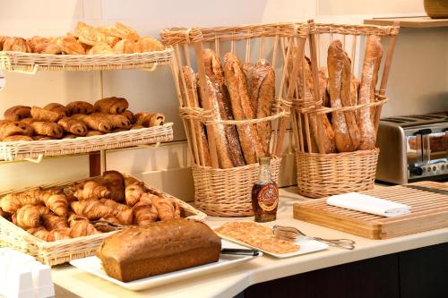 a counter with baskets of bread and pastries on it at Château de Pizay in Belleville-sur-Saône