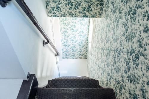 a set of stairs with a window and a curtain at Casa Castelvecchio in Savignano sul Rubicone