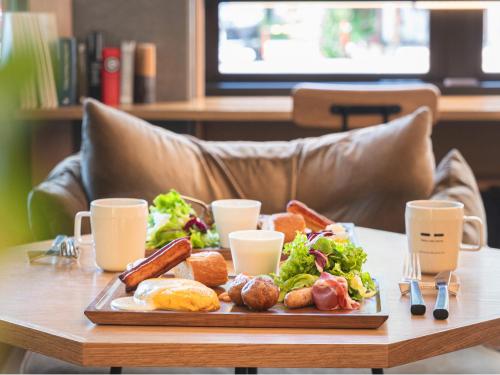 a tray of food on a table with a plate of food at Twin-Line Hotel Karuizawa Japan in Karuizawa