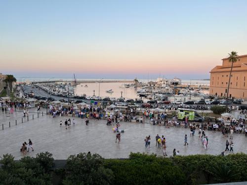 a group of people walking around a plaza near the beach at Una finestra sul mare in Bari