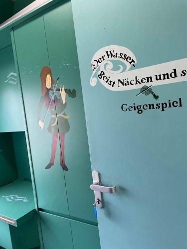 a sticker of a woman taking a picture in a bathroom at zz_Lokschuppen Pasewalk-Erlebnisübernachtung im Schlafwagen in Pasewalk
