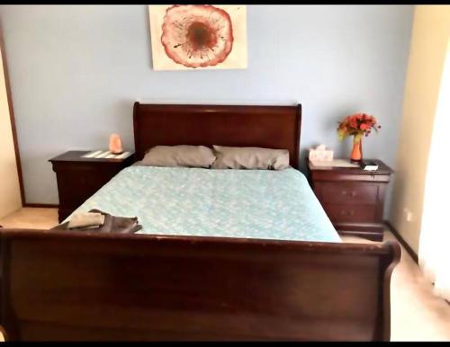 a bedroom with a bed and two dressers and avertisement at Diggers Dealers Accommodation in Kalgoorlie