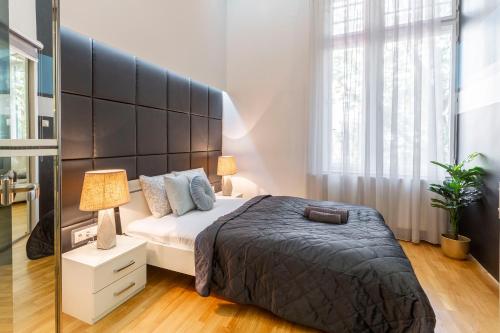 a bedroom with a large bed and a large window at Luxurious & Spacious Downtown Residence in Liszt Ferenc Square in Budapest