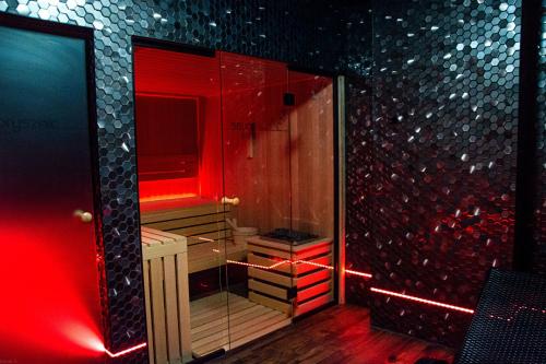 a bathroom with a shower with red lights in it at Pyszna Stajenka in Bąków