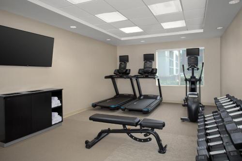 a gym with two tread machines and a flat screen tv at SpringHill Suites by Marriott Portland Vancouver in Vancouver