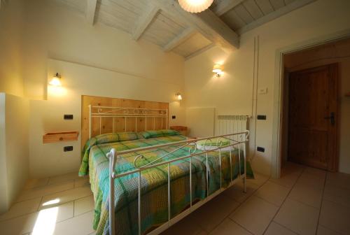 a bedroom with a bed with a wooden headboard at Spoleto by the pool in Spoleto