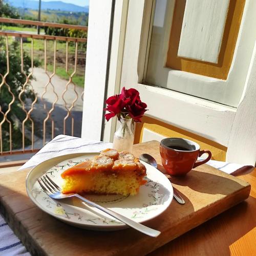 a piece of cake on a plate with a cup of coffee at B&B La Ciammaruca in Pollutri