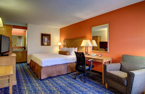 a hotel room with a bed and a desk at Best Western Dulles Airport Inn in Sterling