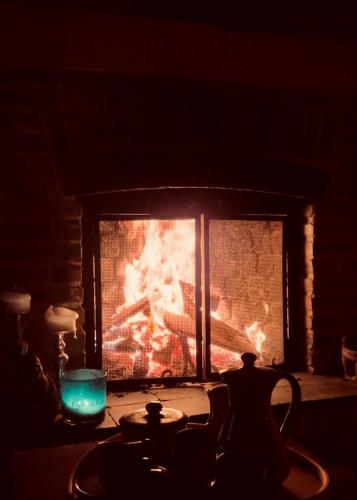 a fireplace in a dark room with a fire in it at De Zwarte Stok in Riemst