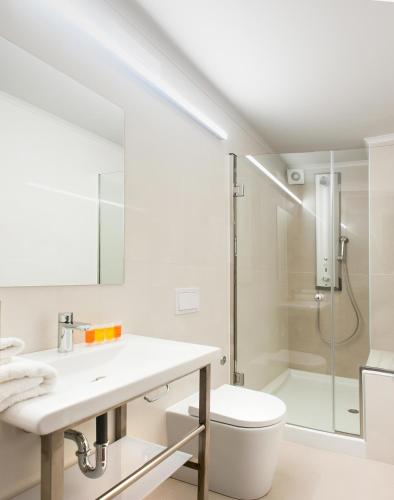 a bathroom with a shower and a toilet and a sink at Splanzia Boutique Hotel in Chania