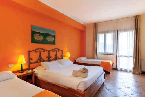 Posteľ alebo postele v izbe v ubytovaní iH Hotels Le Zagare Resort