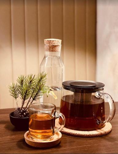 a glass jar of tea and a bottle of whiskey at Spacious King Room on the Heart of Chiswick West London in London