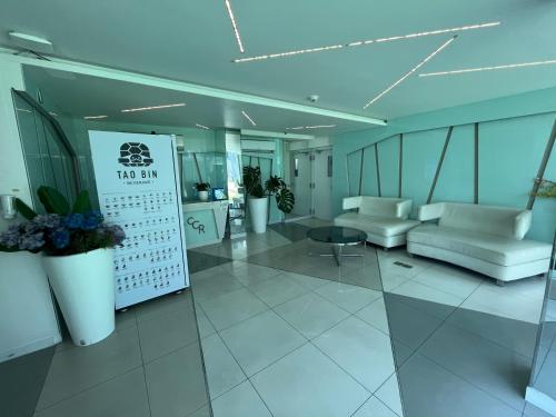 a lobby with white furniture in a building at City center residents Pool view in Pattaya Central