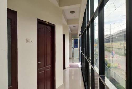 a hallway with a brown door in a building at Rosh Tower in Trivandrum