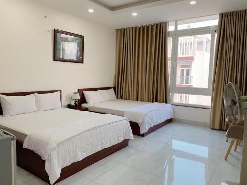 Giường trong phòng chung tại Song Vi Hotel