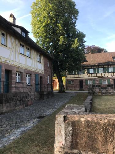 an old building with a tree in front of it at Behringers City Hotel Nürnberg in Nuremberg