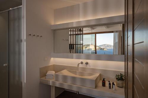 a bathroom with a sink and a mirror at Thesan Villas in Marathias