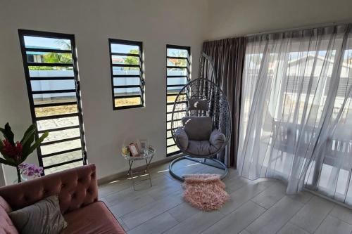 a living room with a couch and a chair at Paradijs in Paramaribo in Paramaribo