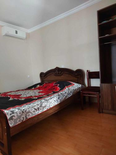 a bedroom with a bed and a chair in it at Guest House GioRgi in Kobuleti