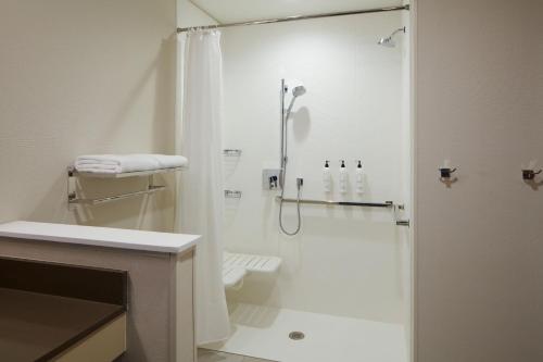 a white bathroom with a shower and a toilet at Fairfield by Marriott Inn & Suites Middletown in Middletown