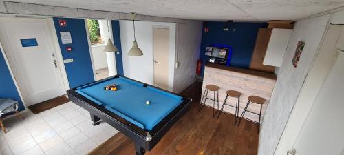 an overhead view of a pool table in a room at La Villa Blanche in Houffalize