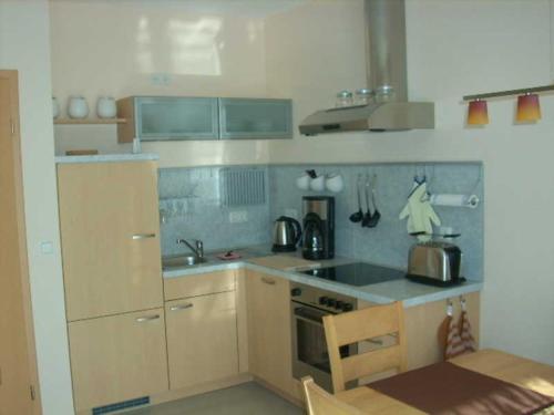 a kitchen with a sink and a stove top oven at Ferienwohnungen mit Boot DH-20952 in Lubmin