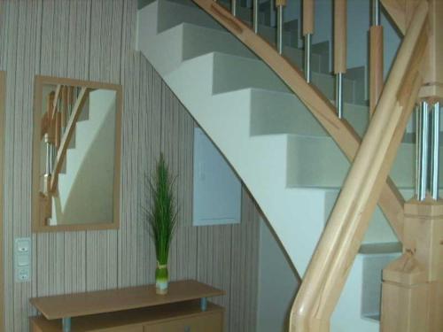 a staircase with a vase with a plant on a table at Ferienwohnungen mit Boot DH-20952 in Lubmin