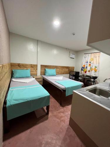 a hospital room with two beds and a sink at Maila's Lodging House in Casisang