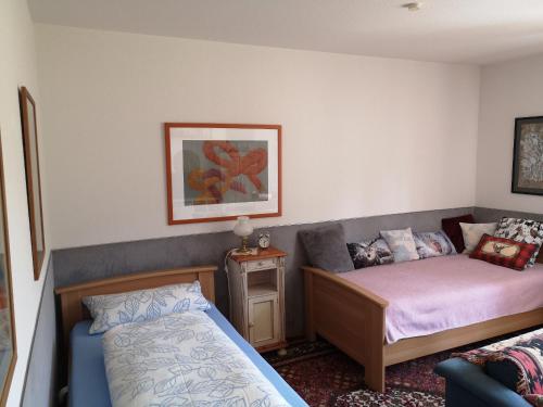 a room with a bed and a couch in it at Haus Am Waldpark in Sankt Georgen im Schwarzwald